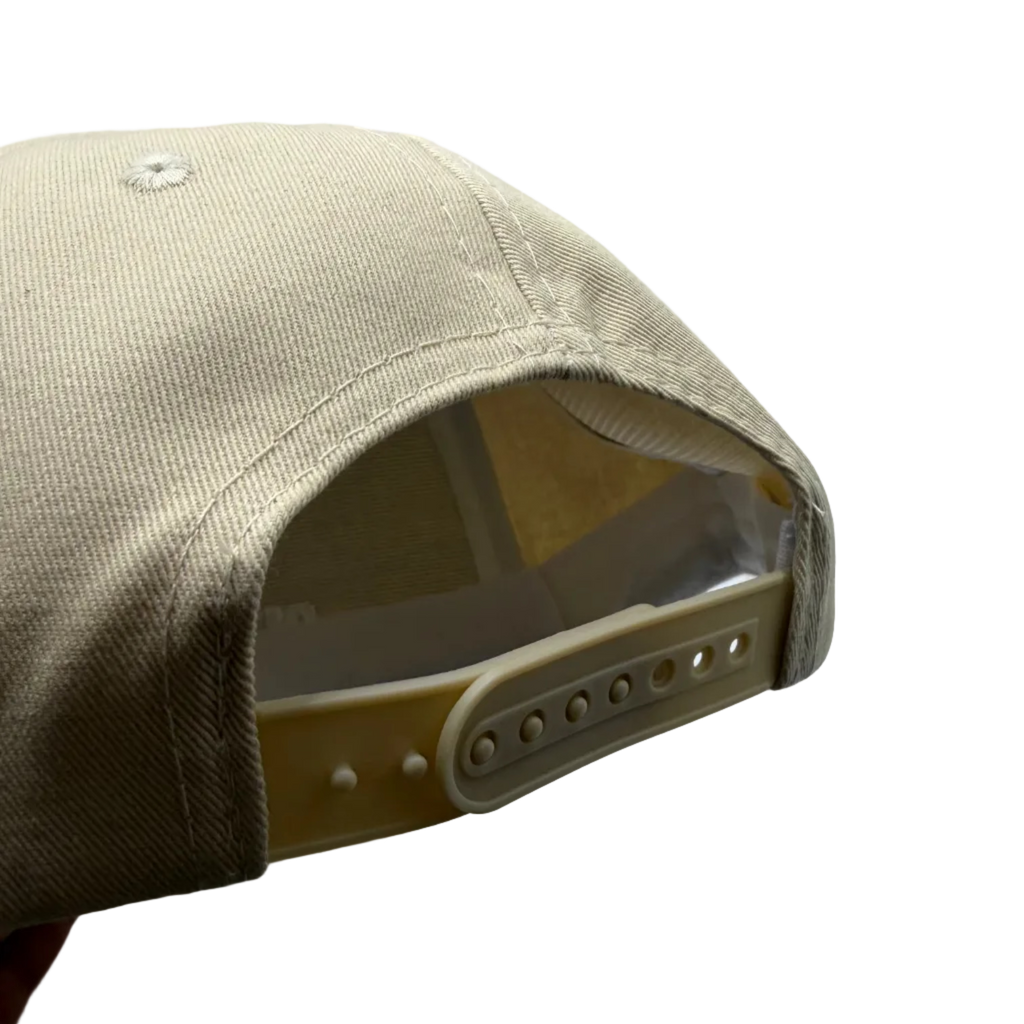 Beige cap with a clear visor on a light gray background